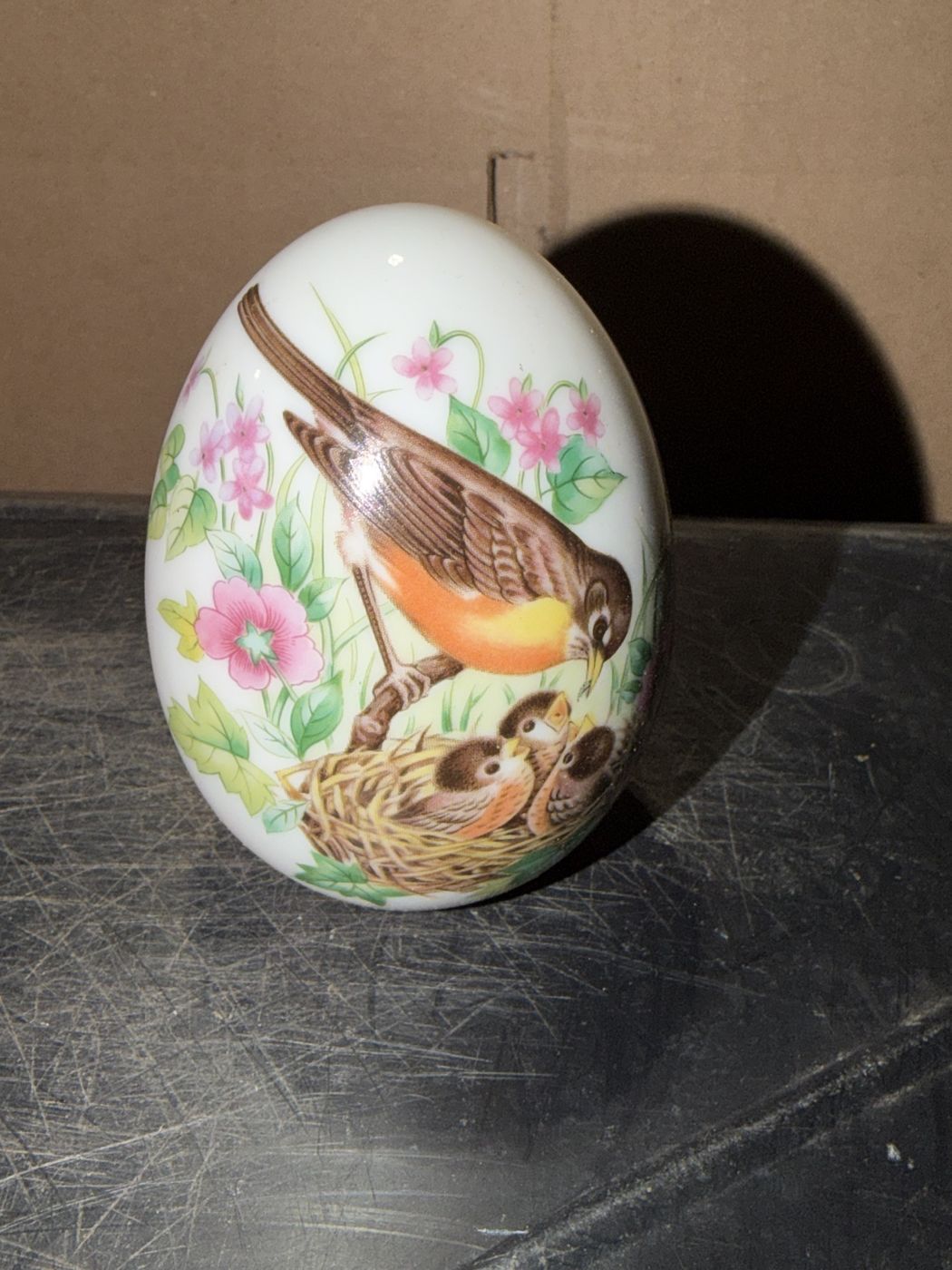 Avon Four Seasons porcelain egg with a robin feeding chicks in a nest