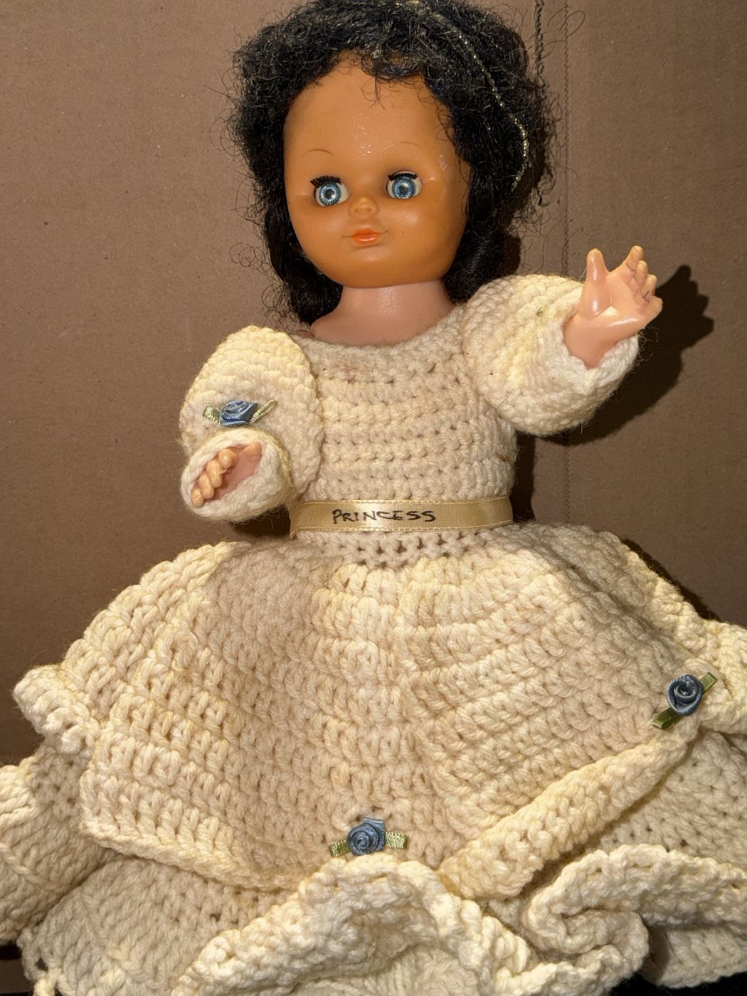 Vinyl sleep eye doll in a cream crocheted gown with a PRINCESS sash